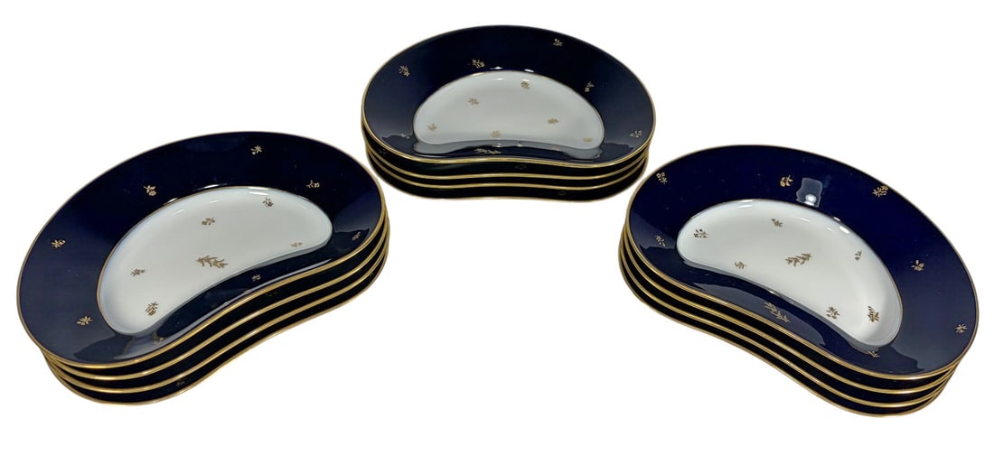 Sevres Style Cobalt Blue & Gilt Plates 12pc LOT: French Sevres style porcelain 12-piece crescent form plate group in cobalt blue and white with gilt trim and delicate gilt floral decoration. Marked Manufacture Nationale Dore a Sevres. Each piece mea
