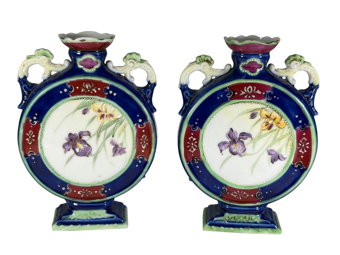 Pair Chinese Style Floral Porcelain Moon Flasks: Pair of Chinese style porcelain moon flasks featuring colorful cobalt blue, red, green, and white decoration with hand-painted floral motifs and stylized double handles. Decorative matching pair with