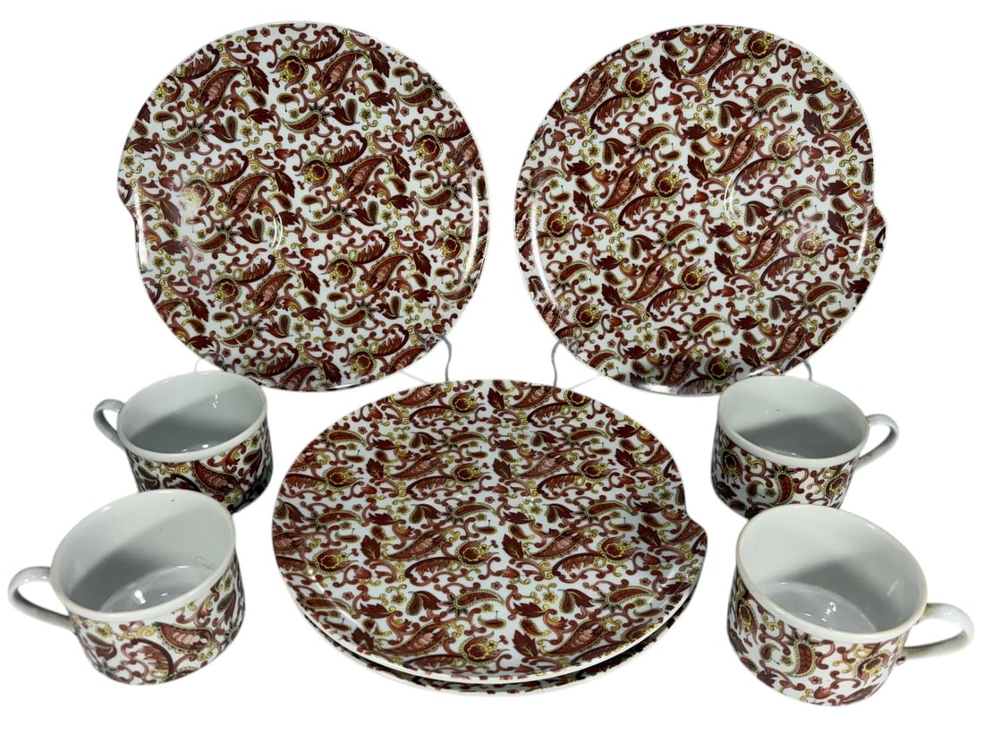 Paisley Porcelain Demitasse Coffee/Tea Service 8pc: Eight-piece porcelain demitasse service comprising four cups and four matching saucers featuring an allover paisley motif in warm red, orange, and gold tones on a white ground. The saucers measure