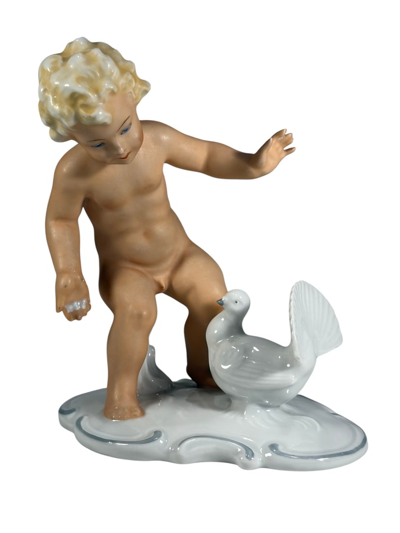 German Schaubach Kunst Porcelain Child Figure: German porcelain figural sculpture by Schaubach Kunst, depicting a nude child figure interacting with a bird on a shaped white porcelain base with pale blue accent decoration. Hand-painted with natura