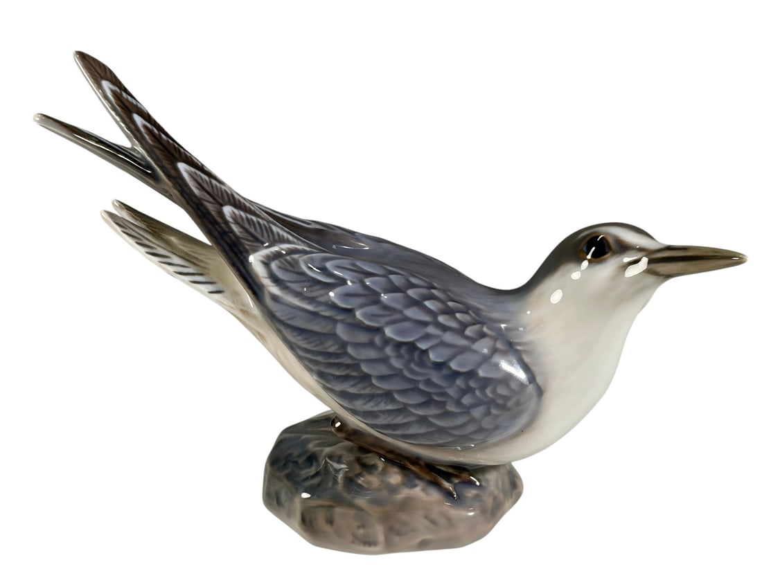 Dahl Jensen Little Tern Porcelain Figure 1319: Dahl Jensen Danish porcelain figure depicting a Little Tern, model no. 1319. Finely hand-painted in pale blue, gray, and white tones, modeled perched on a naturalistic base. Underside marked with Dahl