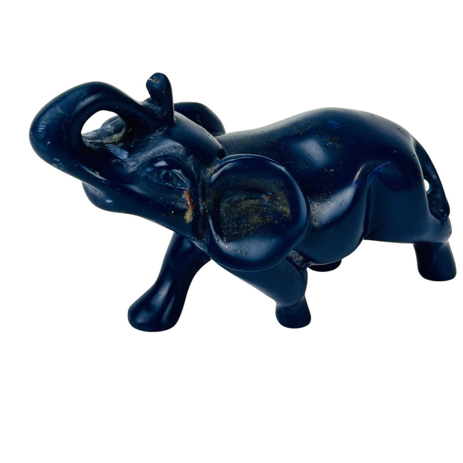 Lapis Lazuli Carved Gemstone Elephant Sculpture: Hand carved and polished semiprecious hardstone figurine. Depicting an elephant with raised trunk, modeled in standing pose. Solid construction with rounded body and short legs and smooth mirror polis