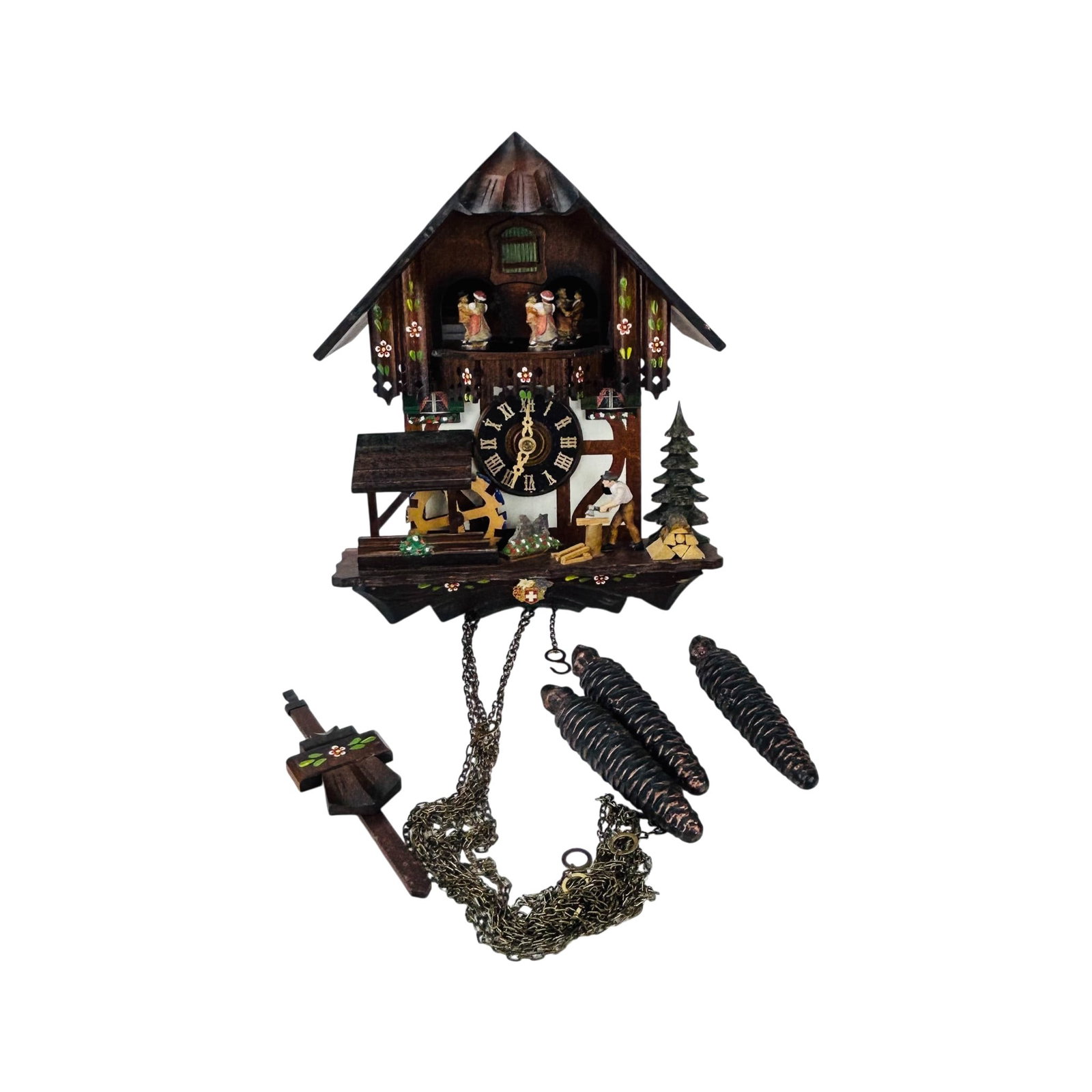 Swiss Romance Musical Chalet Figural Cuckoo Clock: Swiss carved wood chalet form cuckoo clock with Romance Swiss musical movement. Decorated with hand painted floral accents, rotating dancing couples, water wheel, wood chopper figure, and pine tree mo