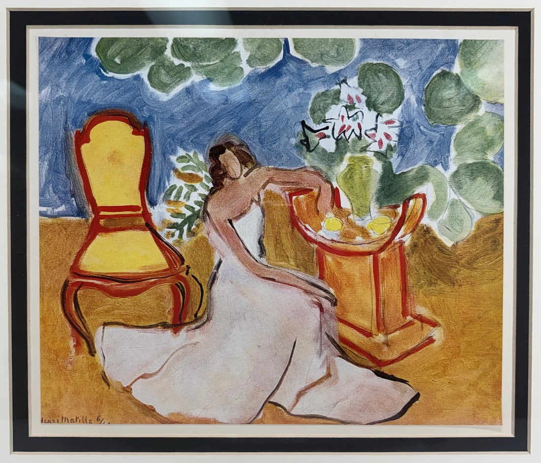 Henri Matisse Interior Scene Giclee Framed Print: Framed giclee print on paper after Henri Matisse depicting a seated female figure within an interior scene beside stylized furnishings and floral elements. The composition features vivid coloration
