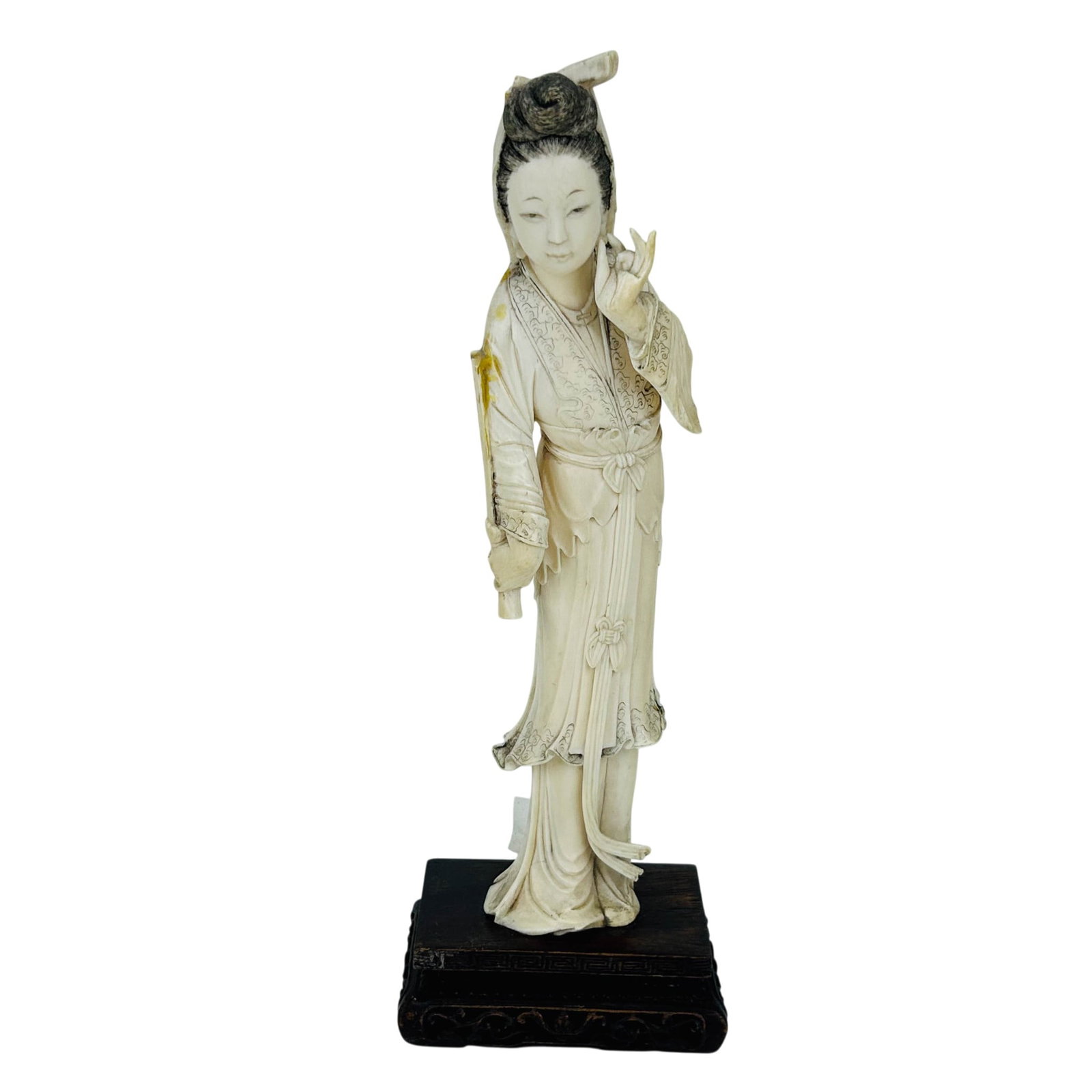 Chinese Guanyin Carved Buddhist Deity Sculpture: Chinese figural sculpture depicting Guanyin that is carved from naturally occurring material. Depicts this deity in standing pose, in flowing robes with detailed coiffure and raised hand gesture,