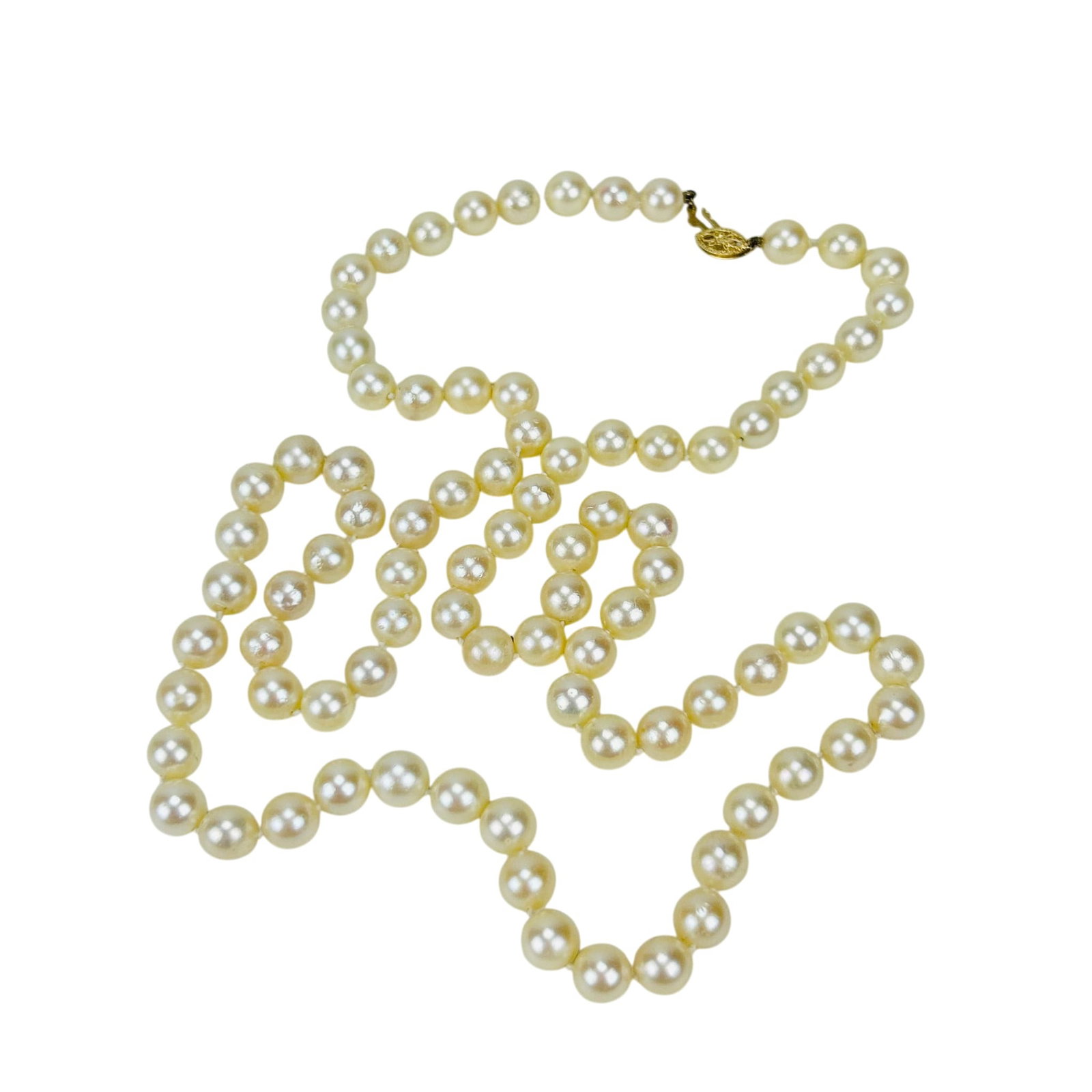 Saltwater Cultured Akoya Pearl Necklace 14K Clasp: Single strand hand knotted saltwater cultured pearl necklace. Comprised of a total of eighty five white pearls and finished with a 14K yellow gold filigree clasp. Pearls display soft luster. Measure