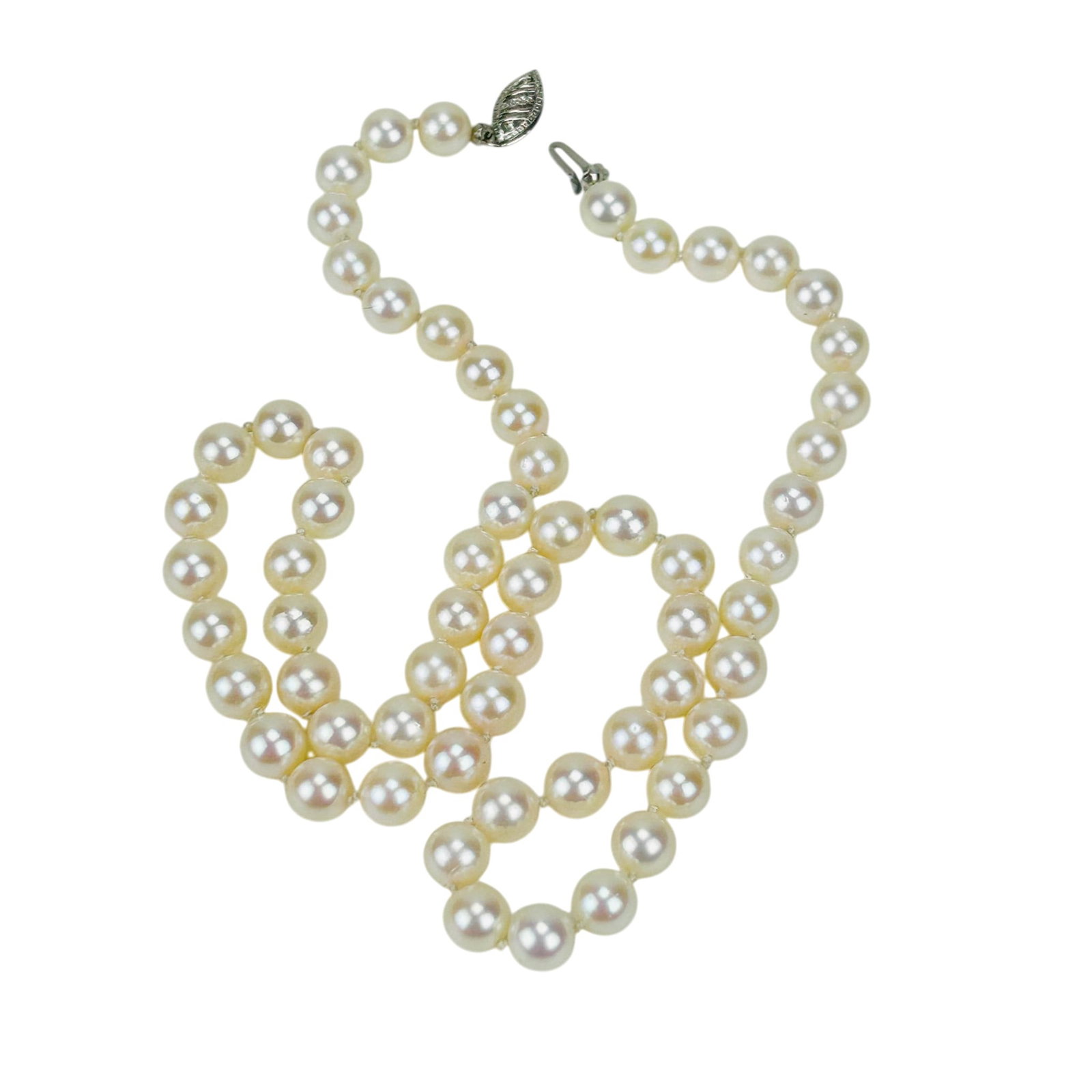 Saltwater Cultured Akoya Pearl Necklace 14K Clasp: Single strand hand knotted saltwater cultured pearl necklace. Comprised of a total of sixty one white pearls and finished with a 14K white gold filigree clasp. Pearls display soft luster measuring