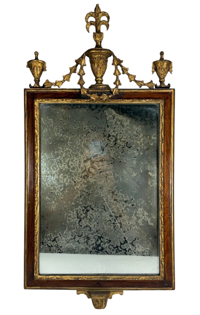 French Louis XVI Style Giltwood Wall Mirror 24.5": French Louis XVI style giltwood wall mirror featuring a rectangular form with molded surround, gilt inner border, and ornate crest with fleur-de-lis finial, urn forms, and draped floral garlands. Reta