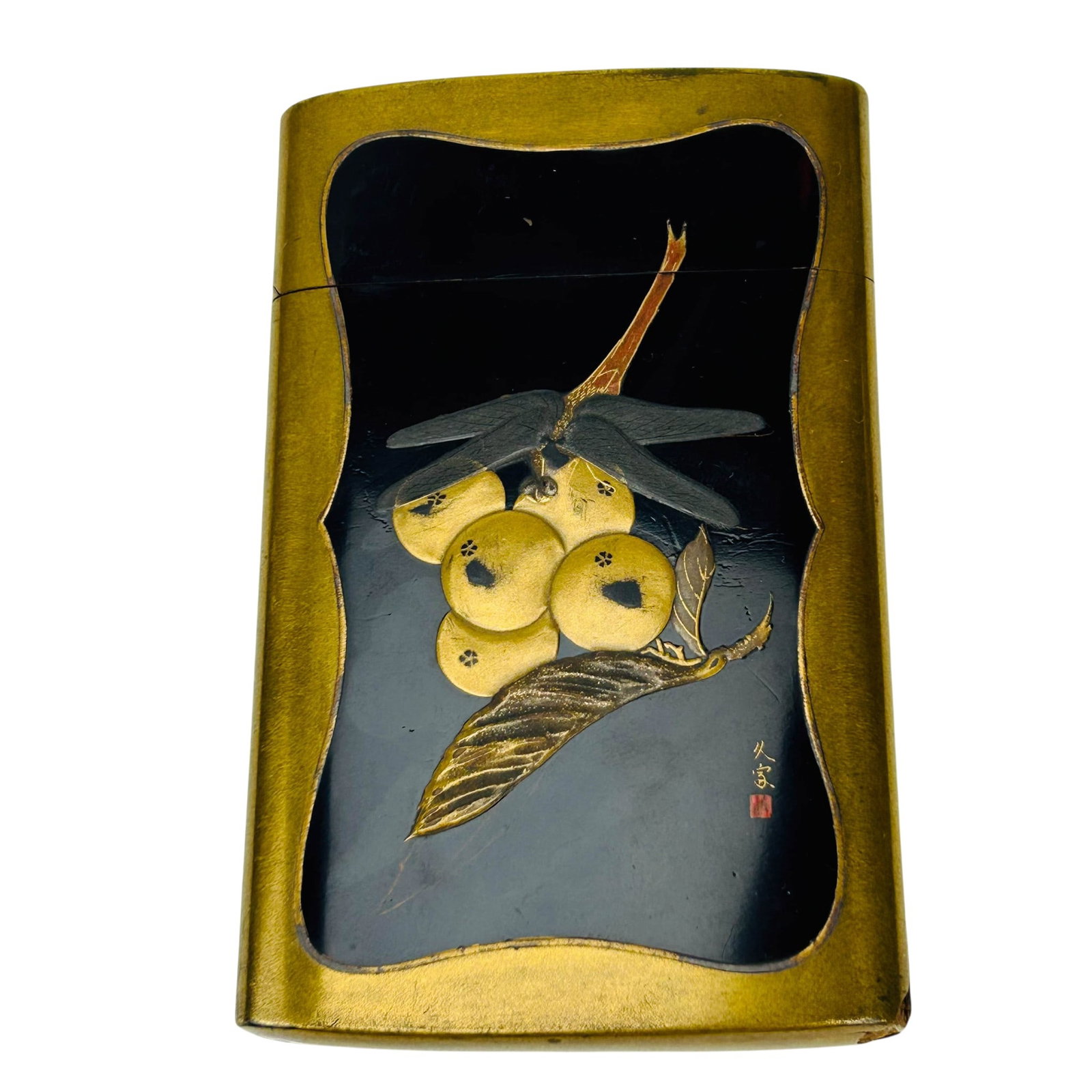 Japanese Lacquered Berry Moth Dragonfly Card Case: Japanese brass tone cigarette case of curved rectangular form with copper toned interior. Exterior fitted with black lacquer panels embellished in gilt and polychrome decoration featuring fruit laden 