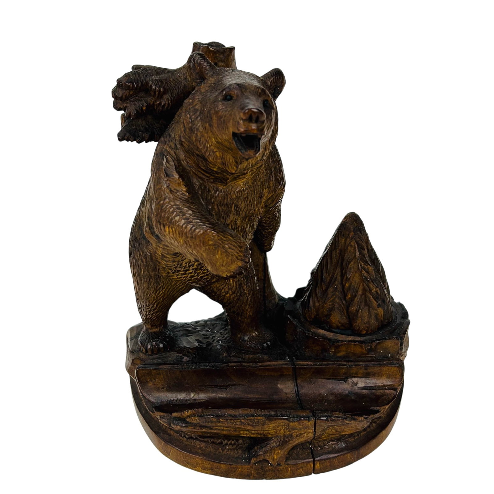 Black Forest Wood Carved Bear Inkwell w/ Pen Rest: Hand carved wooden figural sculpture depicting a standing grizzly bear beside a tree stump, the hinged pine form opening to reveal a fitted glass ink bottle, raised on a shaped base, together with a h