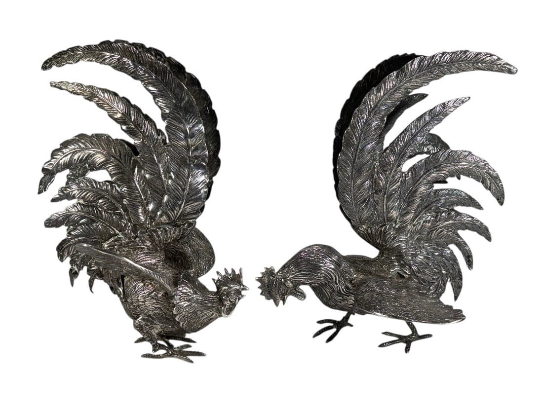 Silvered Bronze Fighting Rooster Sculptures 2pcs: Pair of silvered bronze fighting rooster sculptures with dramatic sweeping tail feathers and finely textured plumage detail. Dynamic opposing poses mounted on integral bases, executed in a stylized na
