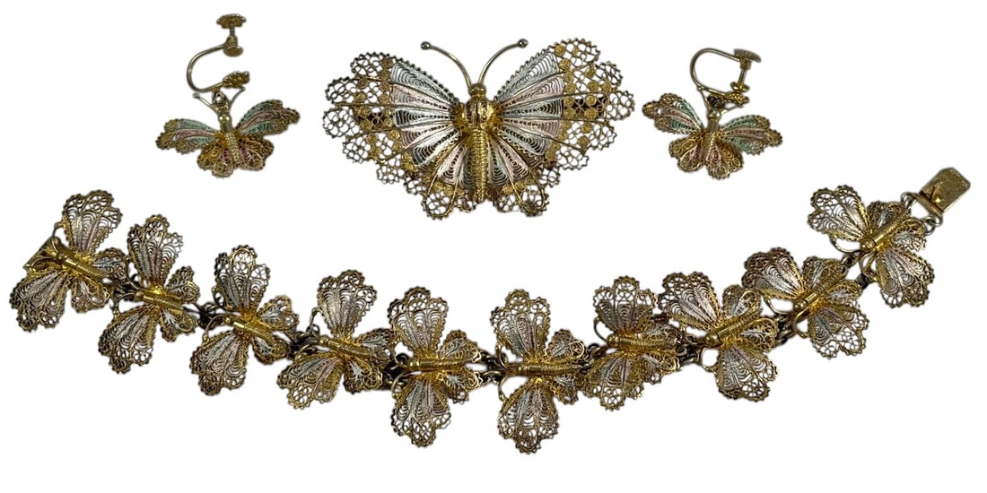 800 Silver Vermeil Filigree Butterfly Jewelry 4pc: Four piece silver filigree jewelry set comprising butterfly motif bracelet, brooch, and pair of screw back earrings. Crafted in vermeil silver with multicolor enamel accents and intricate openwork fil