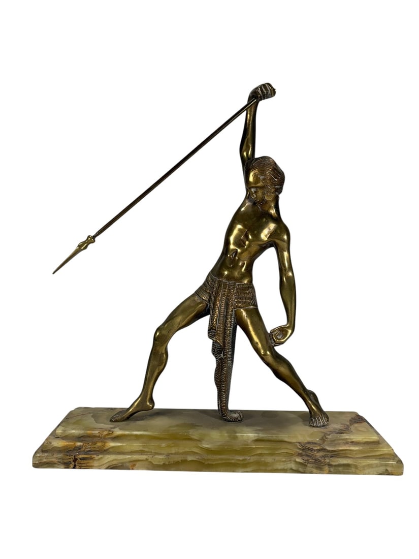 Art Deco Style Bronze Warrior w/ Spear Sculpture: Art Deco style bronze figural sculpture depicting a Roman or Greek warrior holding a spear, mounted on a variegated onyx marble base. Twentieth century. Dimensions: 14.5 X 13.5 X 4.25 in. Condition: