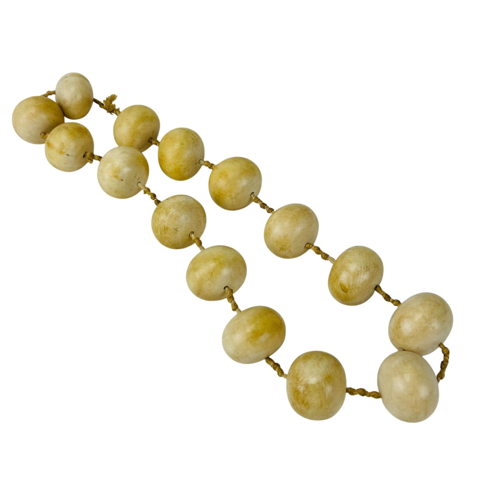 Oversized Hand Knotted Beaded Jewelry Necklace: Single strand necklace composed of oversized carved and polished round beads. Each element is individually knotted on cord spacers. Natural variation throughout the naturally occurring material