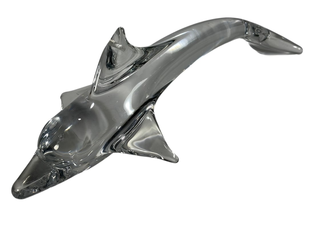 Daum France Clear Crystal Dolphin Sculpture Signed: Clear crystal dolphin sculpture by Daum France, modeled in a graceful leaping form with elongated body, raised dorsal fin, and curved tail. Executed in heavy clear crystal with fluid sculptural lines 