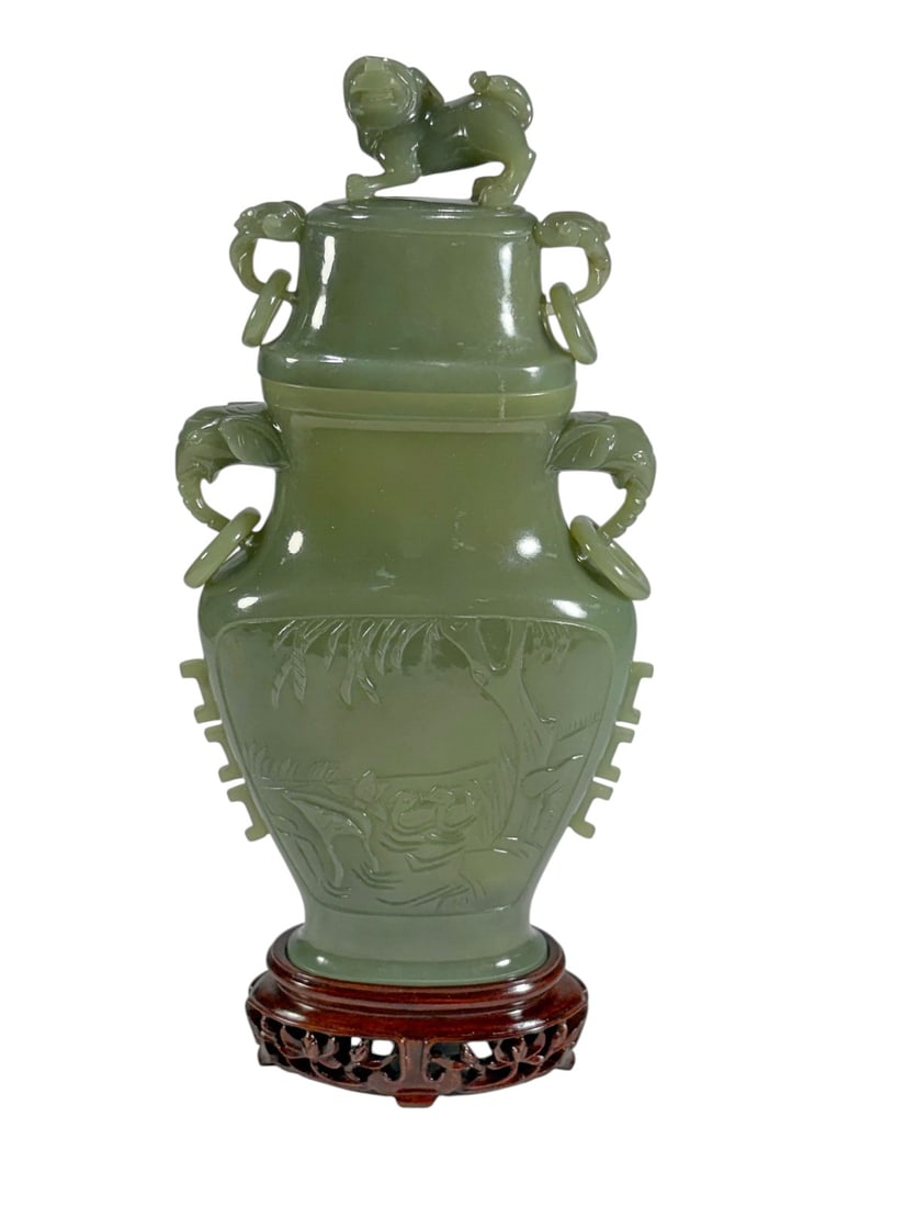 Chinese Green Jade Style Vase, Cover, Stand & Box: Chinese green jade style carved vase with matching cover and carved wood display stand, presented in a fitted silk-lined presentation box. The vase features ring handles flanked by stylized mask motif