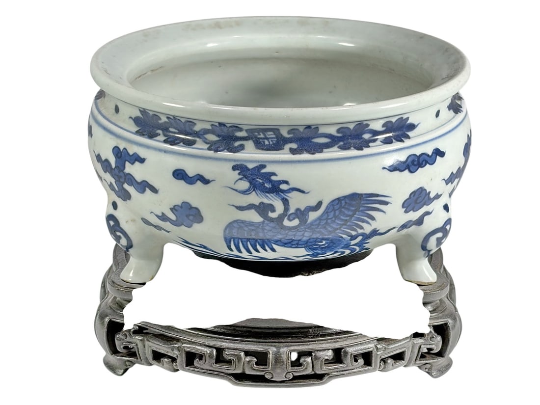 Chinese Blue & White Porcelain Incense Censer: Chinese blue and white porcelain tripod form incense burner censer. Bulbous body with encircling figurative designs of Fenghuang phoenix forms, clouds, scrolling and geometric patterns. Accompanied