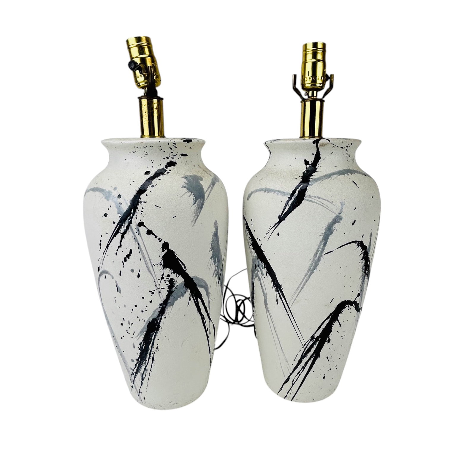 Contemporary Pair Ceramic Drip Glaze Table Lamps: Pair of ceramic desk lamps with baluster form bodies, finished in a textured off white glaze with black and gray drip decoration in an abstract mid century modern style. Each example is mounted with