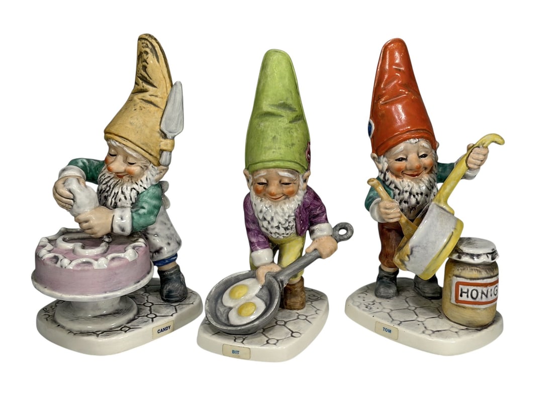 Assorted Goebel Germany Co-Boy Gnome Figurines 3pc: Group of three Goebel Co-Boy porcelain gnome figurines including examples from the popular kitchen and household series. The hand-painted figures depict a gnome decorating a cake, a gnome handling a h