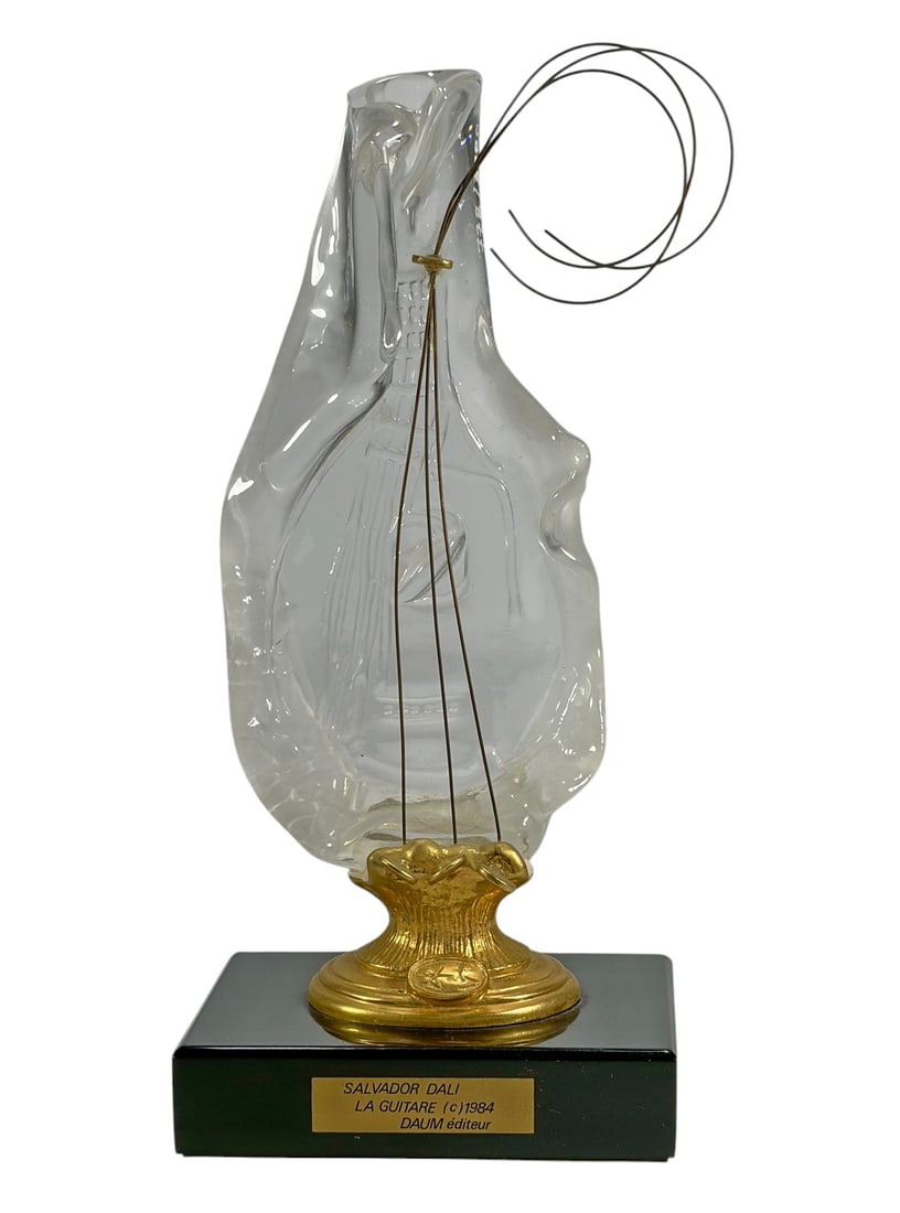 Daum Salvador Dali "La Guitare" Crystal Sculpture: Pate-de-verre crystal sculpture titled La Guitare, designed by Salvador Dali and published by Daum Editeur, 1984. The work depicts a stylized guitar form executed in translucent clear and frosted crys