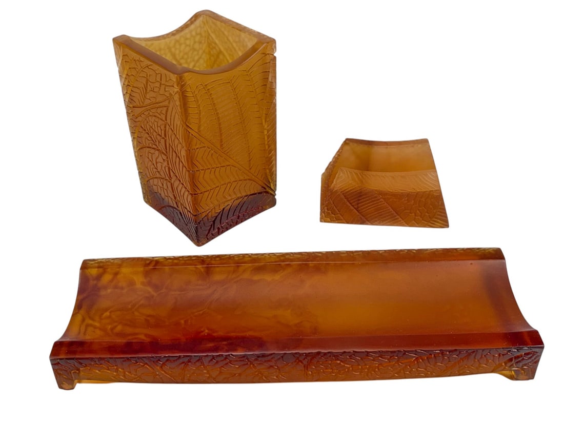 Daum France Floral Pate de Verre Desk Items 3pcs: Daum France Floral Collection pate de verre desk set comprising 3 pieces in amber tones, including a pen holder, pen rest, and memo holder. Decorated with molded leaf motifs and signed Daum France 82.