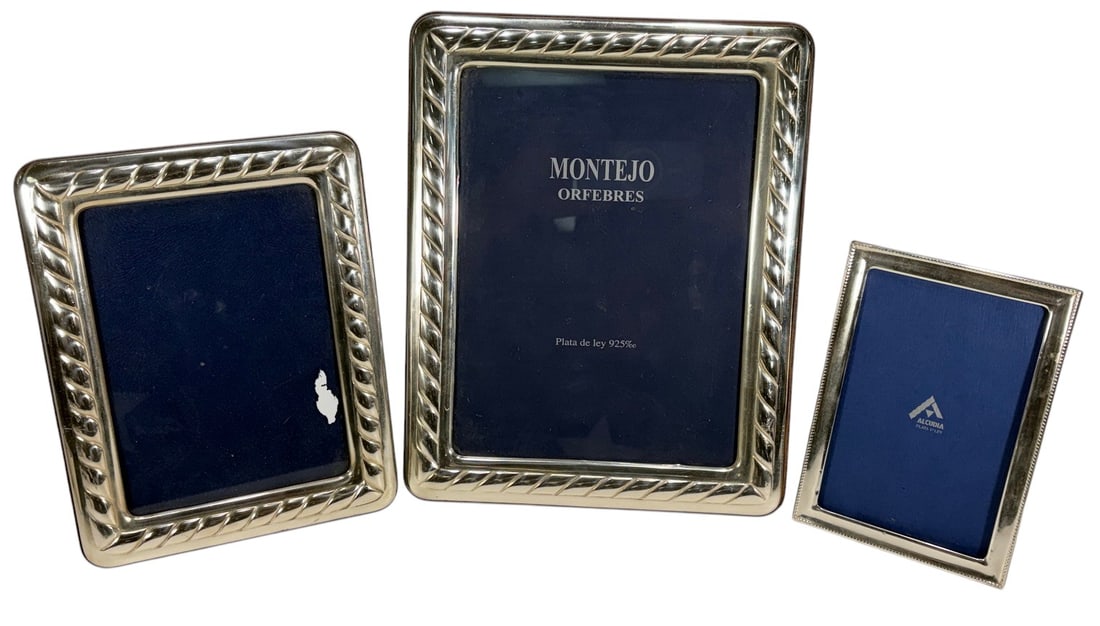 925 Sterling Silver Mounted Picture Frames 3pc LOT: Group of three 925 sterling silver picture frames. Includes two Montejo Orfebres, Madrid frames marked Plata de Ley 925 and one smaller frame. The larger frames have mahogany backs and easel supports,