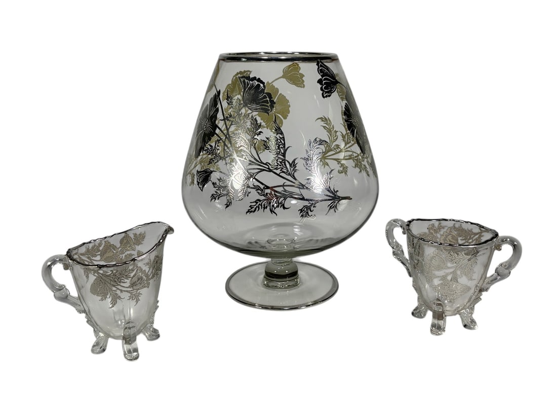 Sterling Overlay Centerpiece, Creamer & Sugar 3pcs: Three-piece glass table set including a footed centerpiece bowl, creamer, and open sugar. Decorated with silver-toned floral overlay and scrolling motifs in the Art Nouveau style. Centerpiece measures