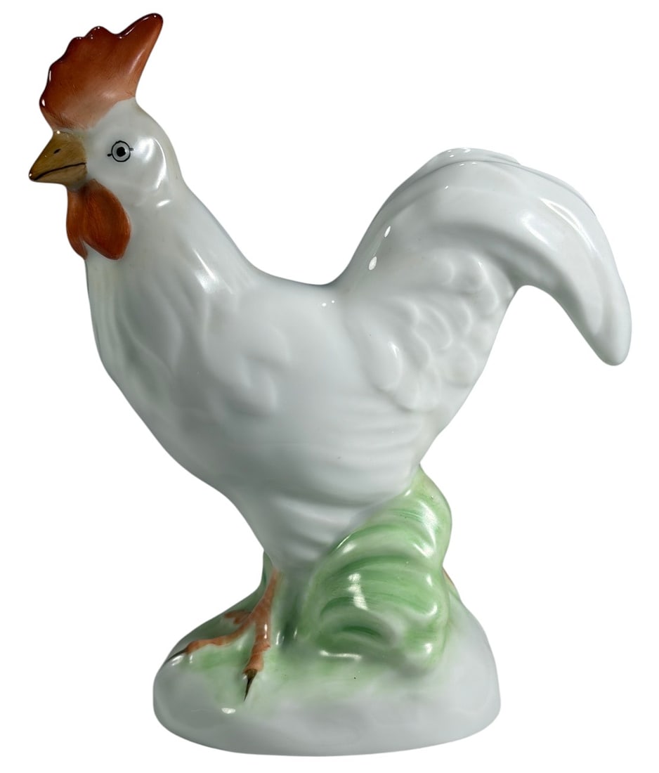 Herend Hungary Hand Painted Porcelain Rooster Fig: Hand-painted Herend Hungary porcelain rooster figurine standing on a green molded base. Decorated with a white glazed body, orange comb and wattles, and finely painted facial details. The underside