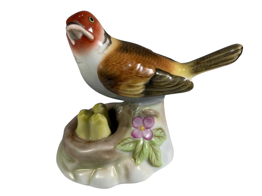 Herend Hungary Hand Painted Bird & Nest Figurine: Herend Hungary hand-painted porcelain figurine depicting a colorful songbird perched beside a nest containing two chicks. The bird is decorated in shades of rust, brown, cream, and yellow with detaile