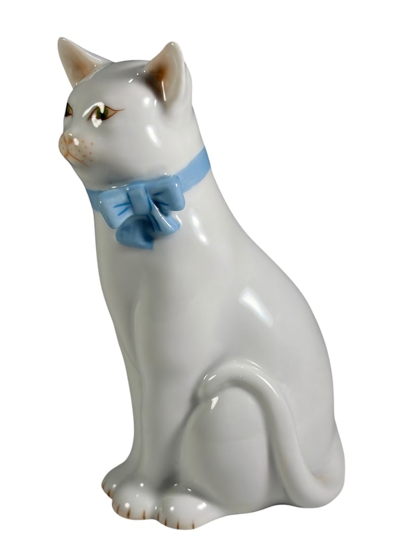 Herend Hand Painted White Cat Figurine w/ Bow: Herend Hungary hand-painted porcelain figurine depicting a seated white cat with green eyes and a light blue bow collar. Finely modeled with detailed facial features and a curled tail, showcasing Here