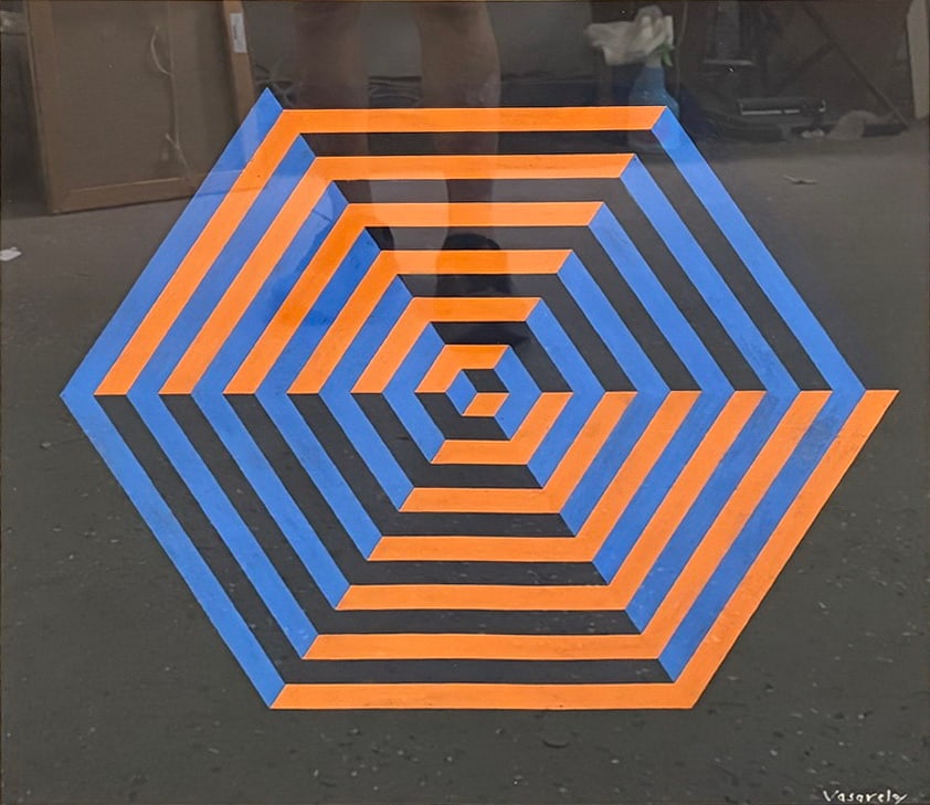 After V. Vasarely Op Art Geometric Work Serigraph: Framed serigraph after Victor Vasarely featuring a concentric hexagonal geometric composition rendered in alternating blue and orange bands against a black ground. The optical design creates a strikin