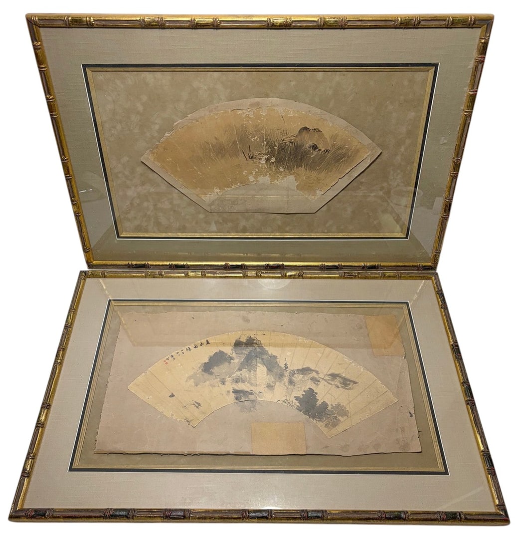 Asian Silk Fan Paintings in Faux Bamboo 2pc LOT: Pair of Asian watercolor and ink paintings on silk in traditional folding fan form. Depict landscape scenes with mountains, trees, calligraphy, and red seals. Mounted under glass with fabric mats in m