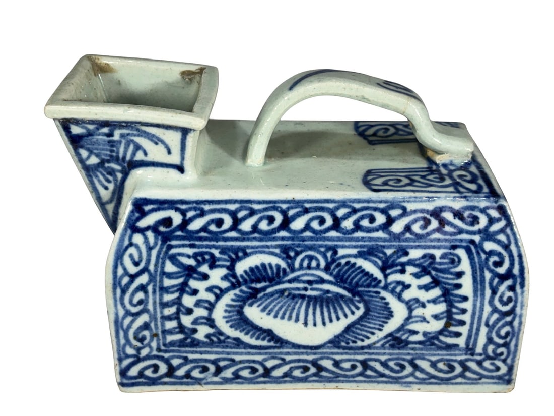 Chinese Blue & White Ceramic Chamber Pot Vessel: Antique Chinese blue and white ceramic chamber pot or urinal of rectangular form, decorated with floral and scrolling motifs in underglaze cobalt blue. The vessel features a curved carrying handle and