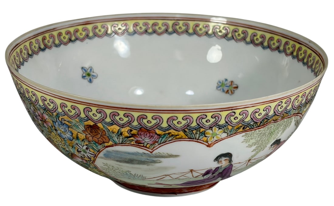 Chinese Famille Rose Porcelain Bowl w/ Figures: Chinese Famille Rose porcelain bowl decorated with figural reserves, floral panels, and scrolling border motifs. Interior with central medallion and floral accents. Red seal mark to base. Dimensions: 