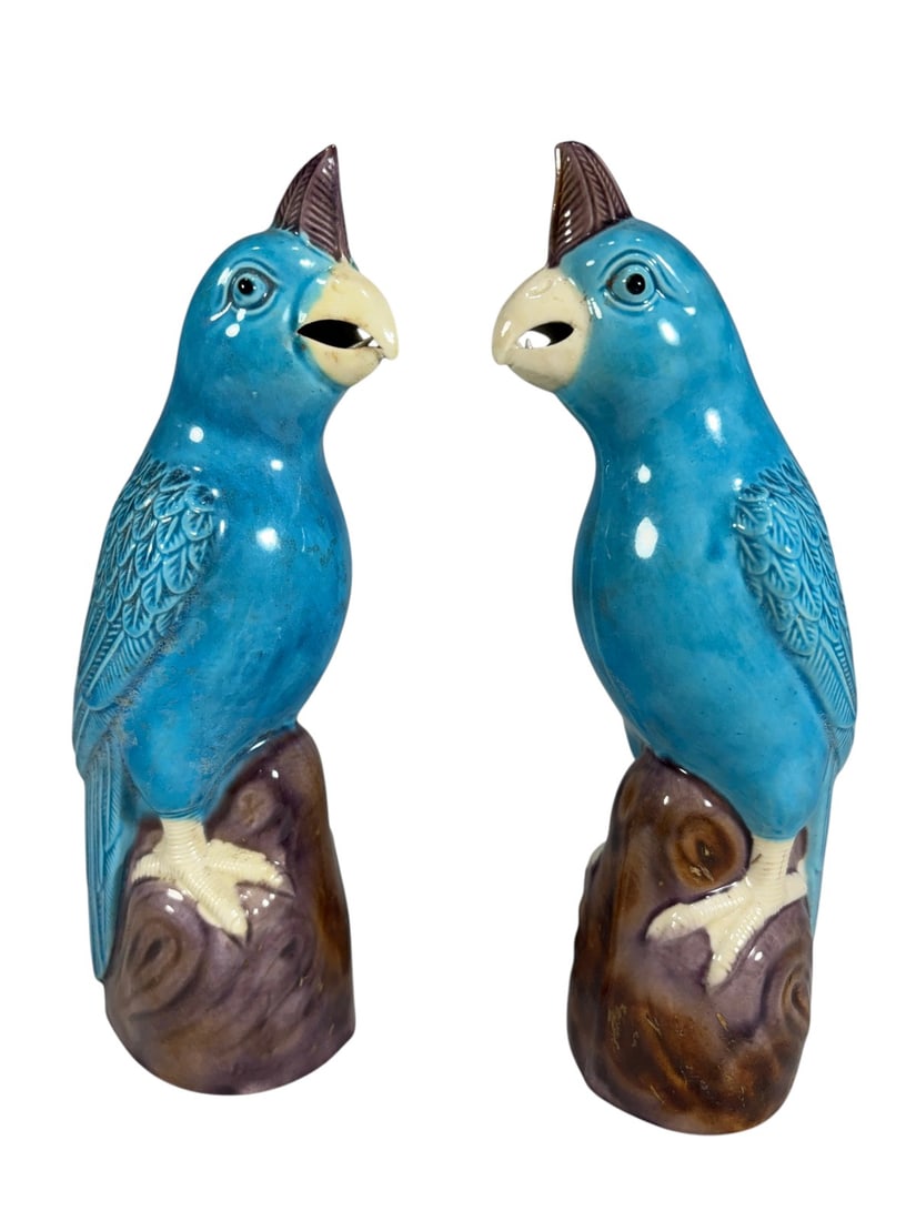 Turquoise Glazed Ceramic Parrot Figures Art 2pcs: Pair of ceramic parrot figures decorated with vibrant turquoise glaze, modeled perched atop tree stump bases. Each bird features molded feather details, cream-colored beaks and feet, and brown glazed 