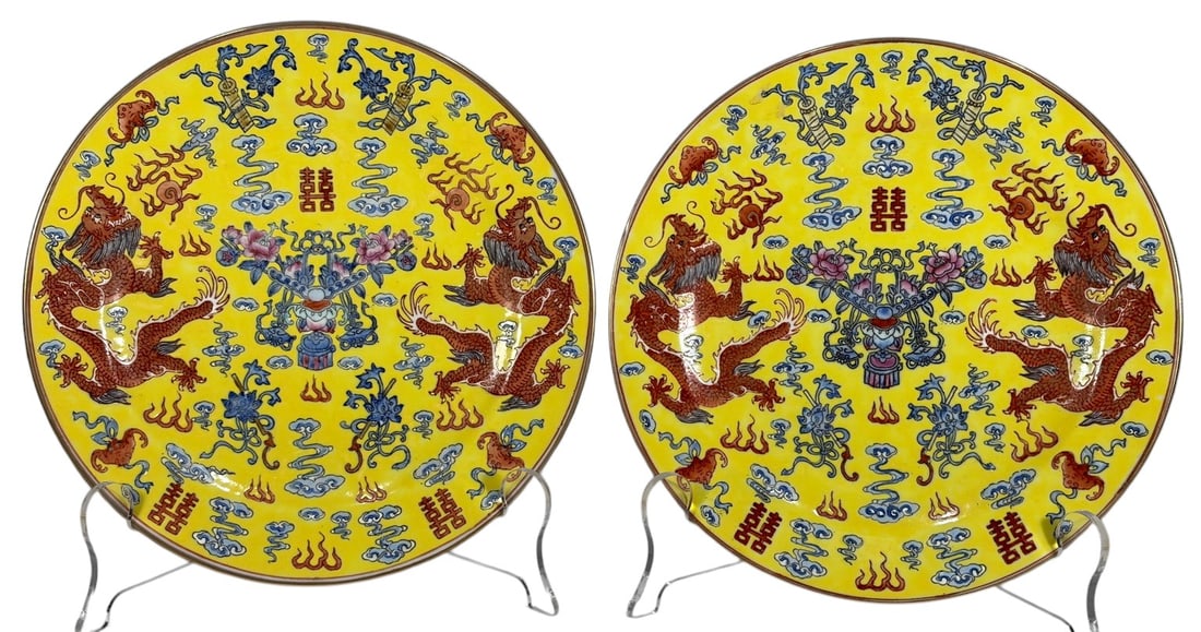 Chinese Yellow Ground Dragon Porcelain Plates 2pcs: Pair of Chinese porcelain cabinet plates decorated in famille jaune style with iron-red dragons, scrolling blue clouds, auspicious emblems, and floral motifs on a bright yellow ground. Each plate bear