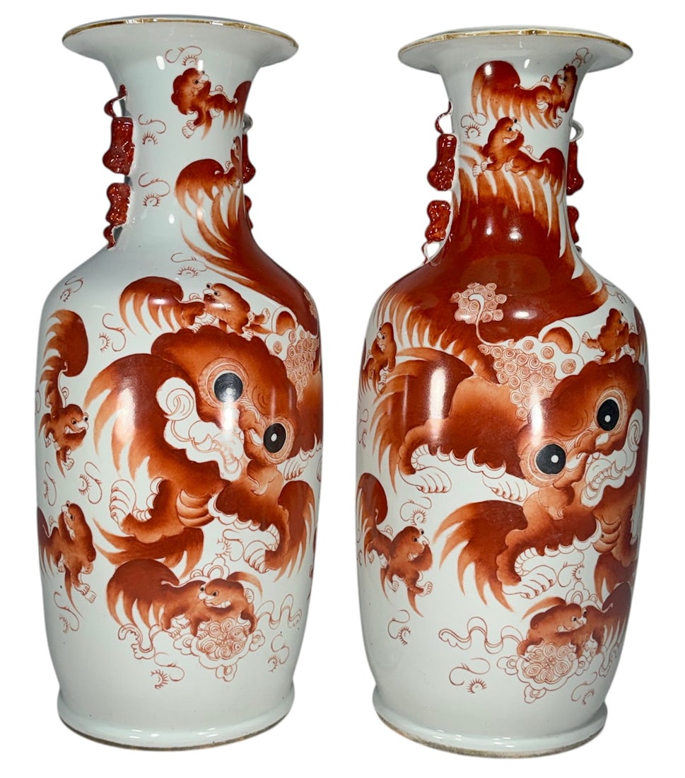 Pair Chinese Iron Red Porcelain Dragon Form Vases: Pair of Chinese porcelain vases decorated in iron red enamels with dragon masks, clouds, flames, and dragon figures. Molded handles, flared rims, and calligraphic inscriptions decorate the reverse. Re