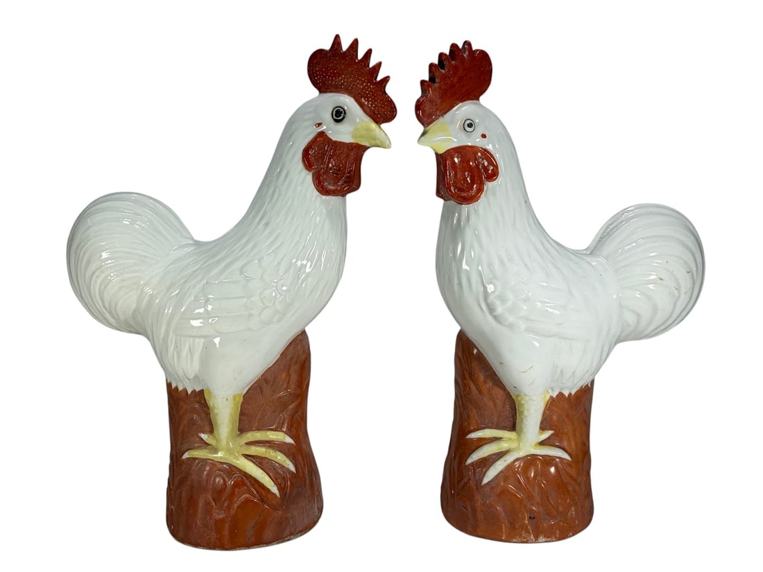 Pair Chinese Blanc de Chine Rooster Figures Style: Pair of Chinese porcelain rooster figures in the Blanc de Chine style, modeled standing atop naturalistic bases. The birds feature white glazed bodies with red combs and wattles, yellow beaks and feet