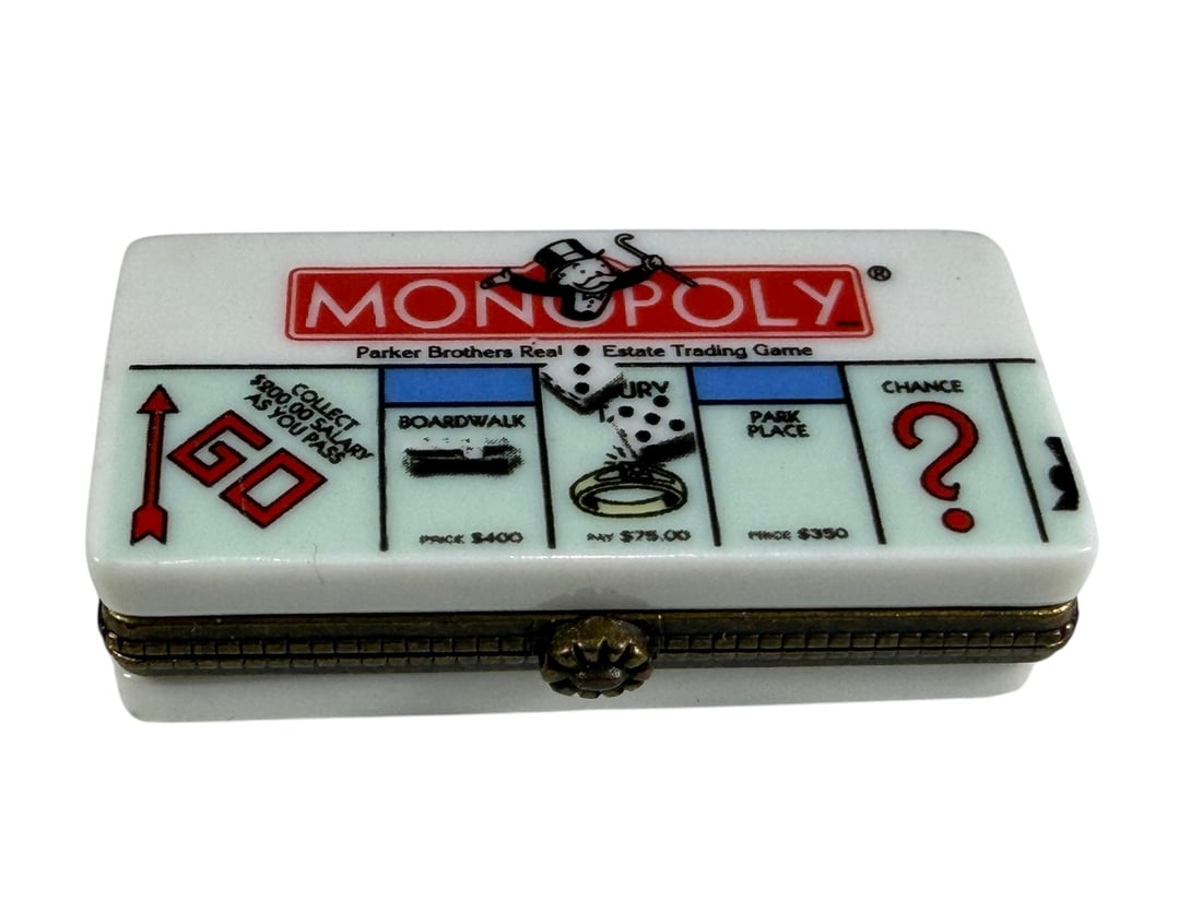 Rochard Limoges Monopoly Game Board Trinket Box: Hand-painted Rochard Limoges porcelain trinket box modeled as a Monopoly game board. The lid features classic Monopoly graphics including the GO space, Chance, Boardwalk, Park Place, dice, and ring to