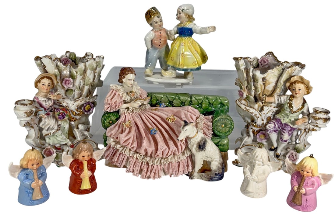 Assorted Porcelain Figurines & Bell Ornament 8pcs: Group of eight ceramic and porcelain pieces including a pair of ornate figural spill vases, four angel bell ornaments, a Germany marked dancing couple figurine, and a lace porcelain lady reclining on 