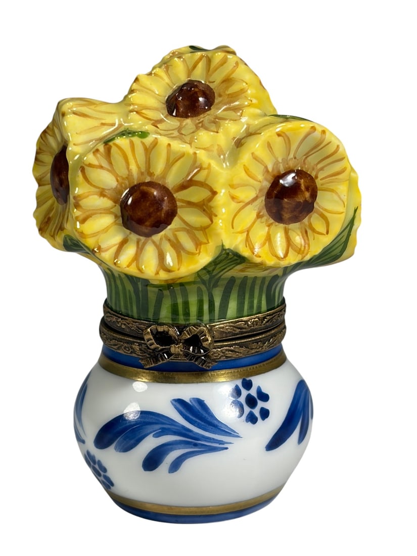 Limoges Sunflower Bouquet Porcelain Trinket Box: Hand-painted Limoges porcelain trinket box modeled as a small blue and white vase holding a bouquet of bright yellow sunflowers with raised petals and green leaves. The hinged lid forms the floral arr