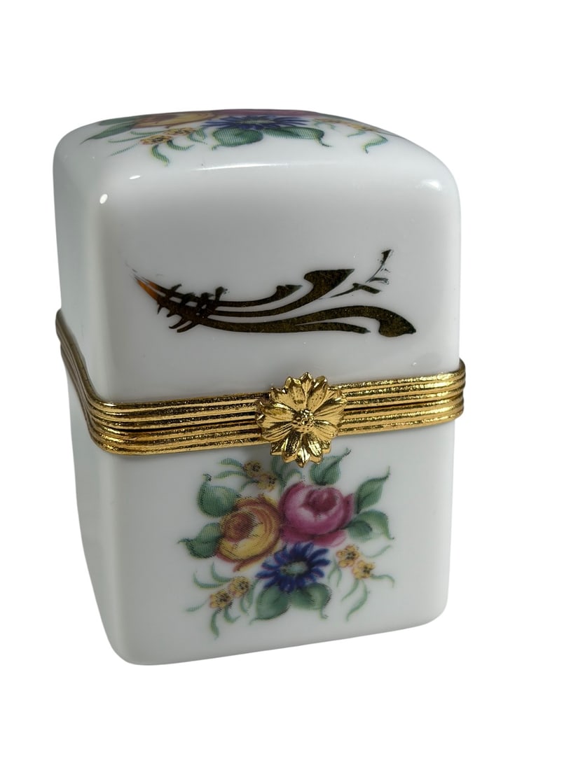 Limoges Floral Porcelain Perfume Bottle Box Set: French Limoges porcelain trinket box of square form with hand-painted floral decoration and gilt scroll accents. The box is fitted with gilt-tone metal mounts and clasp. Accompanied by two miniature g