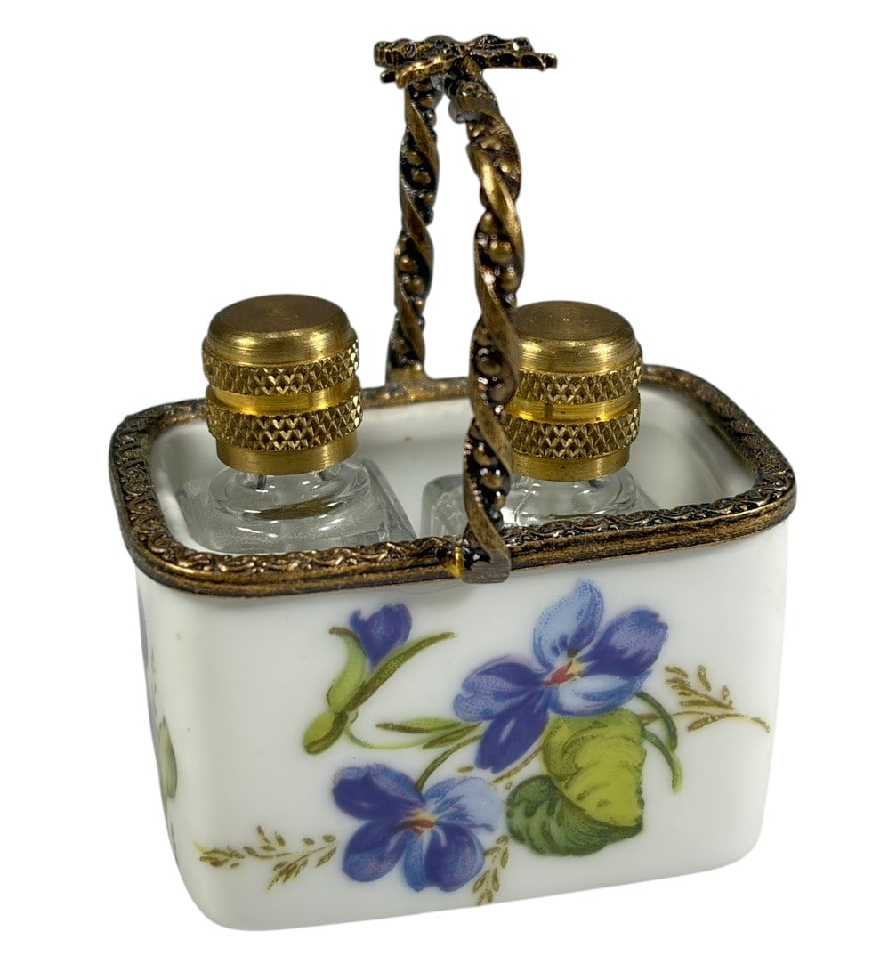Limoges France Porcelain Vanity Set with Bottles: Hand-painted Limoges porcelain vanity or dressing table accessory featuring a rectangular porcelain holder with floral violet decoration and ornate brass-tone metal rim and carrying handle. Includes t