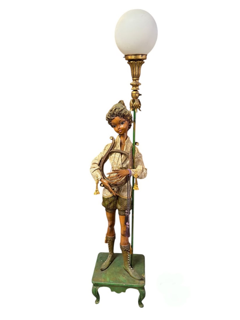 Whimsical Carved Wood Musician Floor Lamp Figure: Decorative floor lamp with a carved wood musician figure holding a lyre, dressed in period-style costume with fabric clothing and painted details. Mounted on a stool-form base with a frosted opaline g