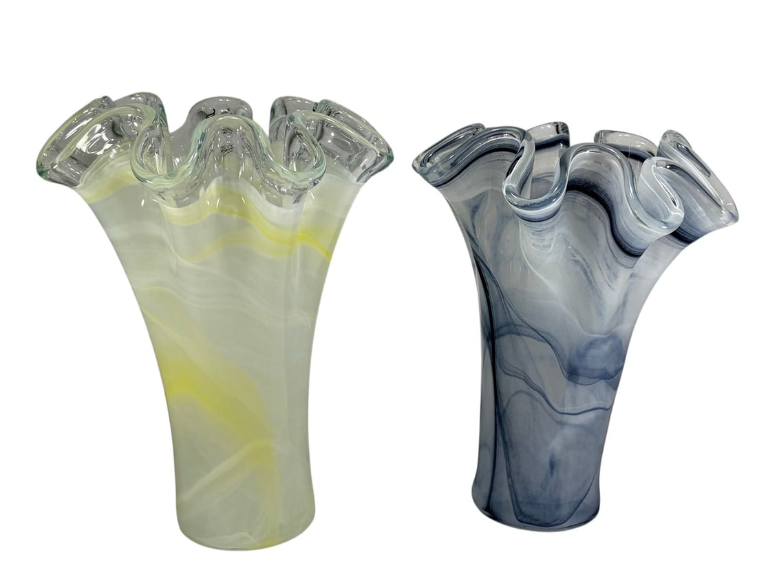 Murano Style Art Glass Ruffled Rim Vases 2pc LOT: Pair of art glass vases crafted in the Murano tradition, each featuring a tall tapered form with dramatic ruffled rims and swirling internal decoration. One vase is executed in opaque white glass with