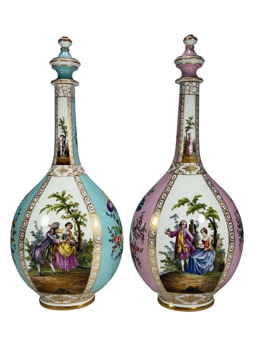 Pair Dresden Porcelain Rococo Scene Urns w/ Lids: Matched pair of Dresden porcelain covered urns with pink and celeste blue grounds. Hand-painted Rococo courting scenes within gilt reserves, accented by floral sprays and extensive gilt decoration. Bo