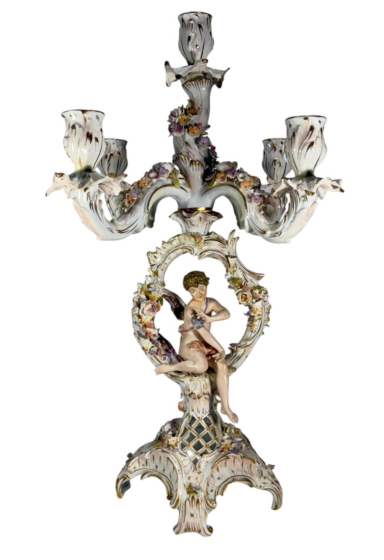 Dresden Style Porcelain Cherub 5 Light Candelabra: Highly decorative porcelain five-light candelabra in the Dresden style, featuring a seated cherub beneath an elaborate floral garland and scrolling rococo framework. Decorated with applied flowers, gi
