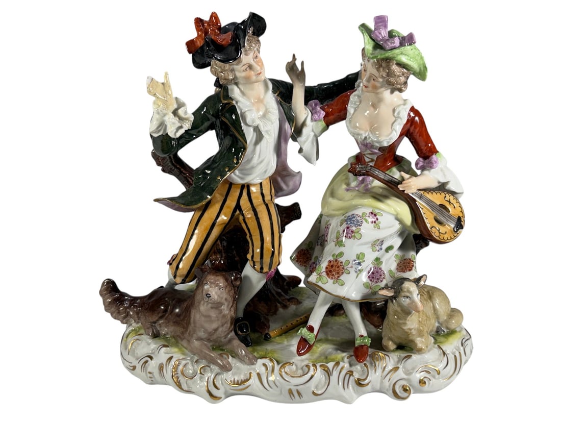 German Porcelain Courting Couple Group Figurine: Fine German porcelain figural group depicting a courting couple seated on tree stumps in 18th-century attire. The gentleman gestures animatedly while the lady holds a stringed musical instrument. A do
