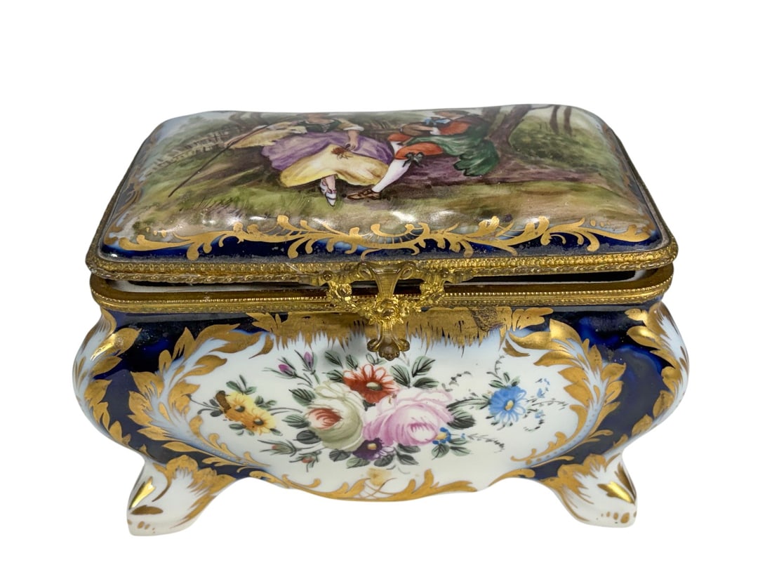 Sevres Style Porcelain Casket w Bronze Mounts Box: Sevres style porcelain jewelry casket with a cobalt blue ground, gilt decoration, and a hand-painted galant scene on the hinged lid. Floral reserves adorn the sides, with gilt bronze mounts, clasp, sh