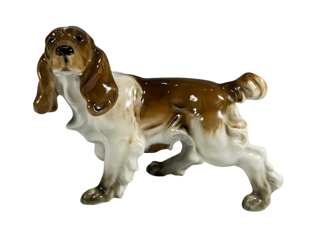 Hutschenreuther Germany Porcelain Spaniel Dog Fig: Vintage Hutschenreuther porcelain figurine depicting a standing spaniel hunting dog with flowing ears, detailed coat, and hand-painted brown and white coloration. Realistically modeled in an alert sta